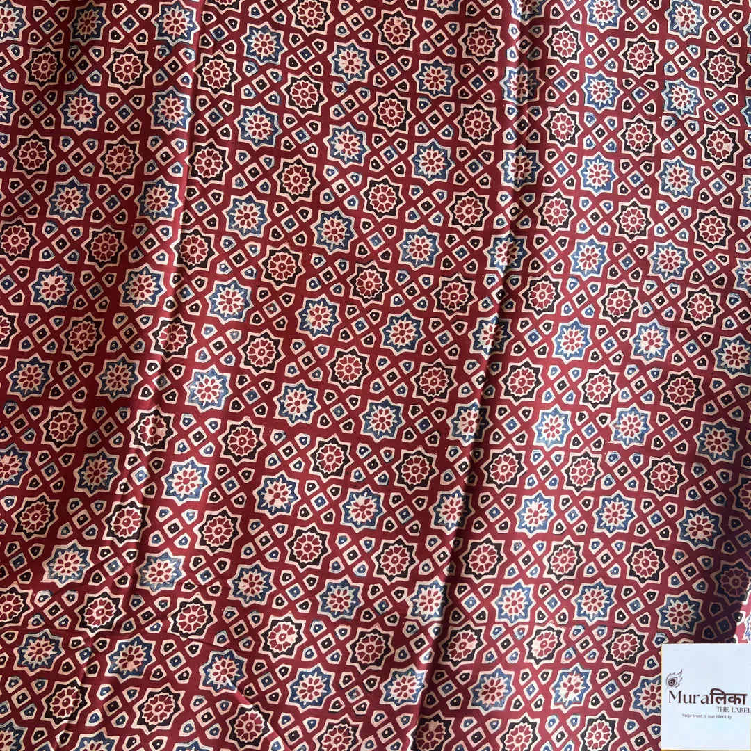Ajrakh hand block printed modal silk saree by Muralika the label, showcasing intricate traditional patterns and vibrant colors.