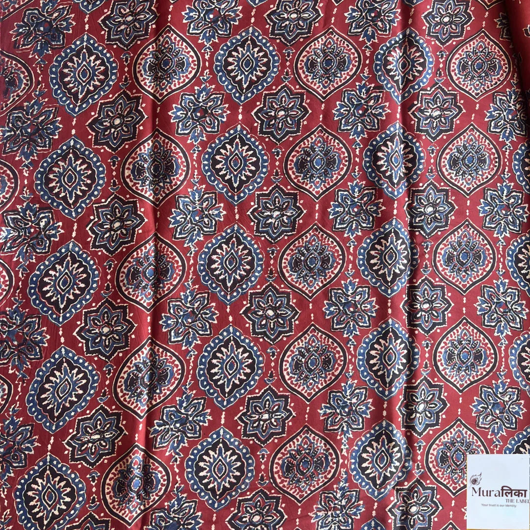 Ajrakh hand block printed modal silk saree by Muralika the label, showcasing intricate geometric patterns and vibrant colors.
