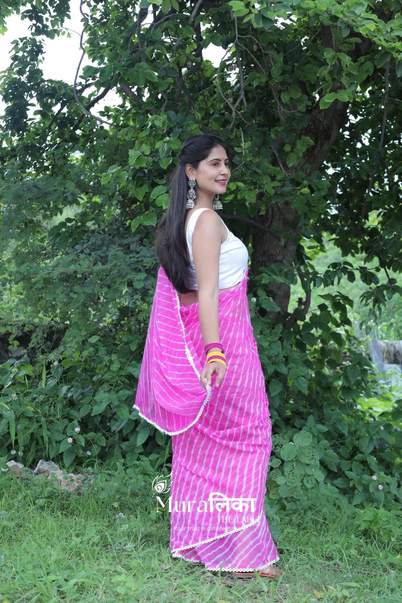 Pink hand-dyed chiffon Leheriya saree by Muralika the Label, showcasing traditional Indian tie-dye fabric with intricate patterns.