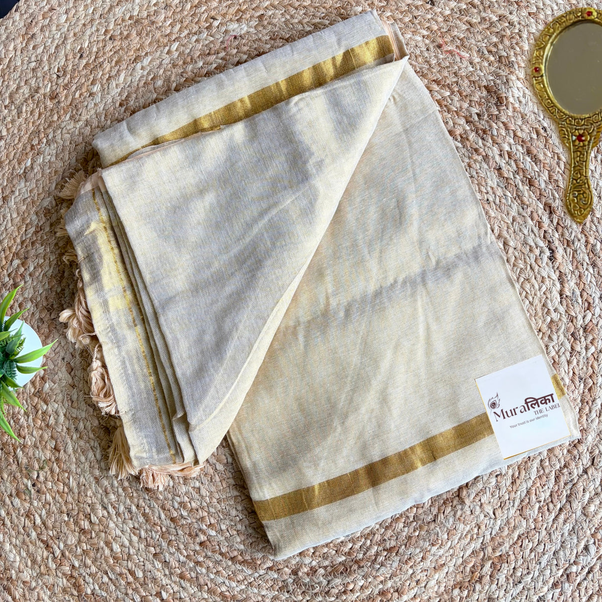 Sunehri cream tissue saree folded to show the blouse piece