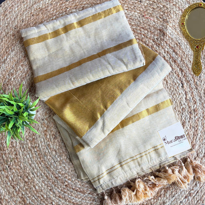 Sunehri kasavu-inspired cream and gold tissue saree shown draped