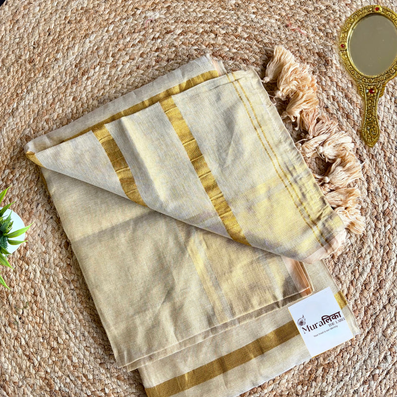 Sunehri cream tissue cotton saree with broad woven gold zari border, folded flat