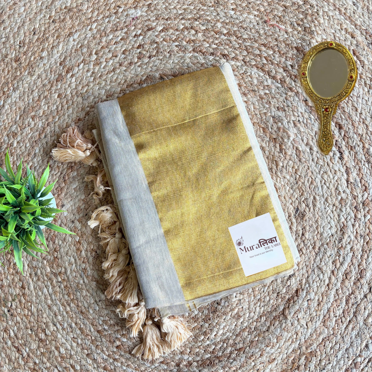 Close view of the cream tissue cotton weave on the Sunehri saree