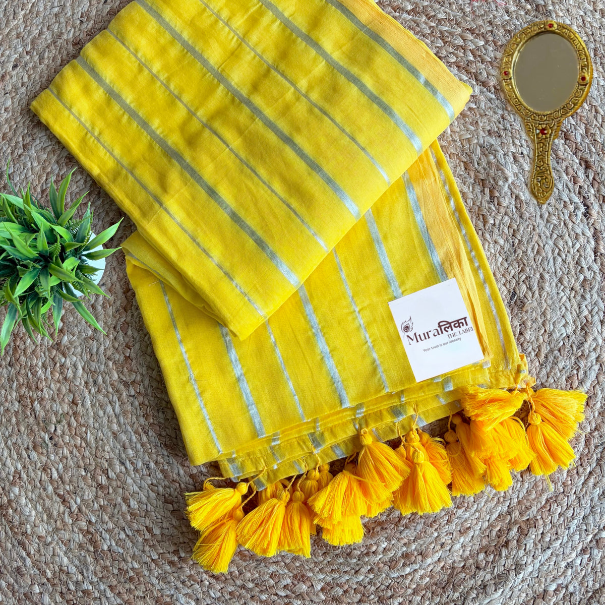 Close view of silver stripes on the Haldi yellow mulmul cotton saree