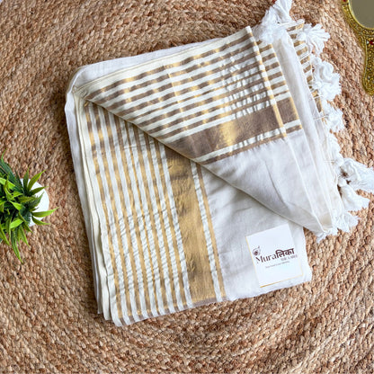 Shwet white mulmul cotton saree draped to show the gold border