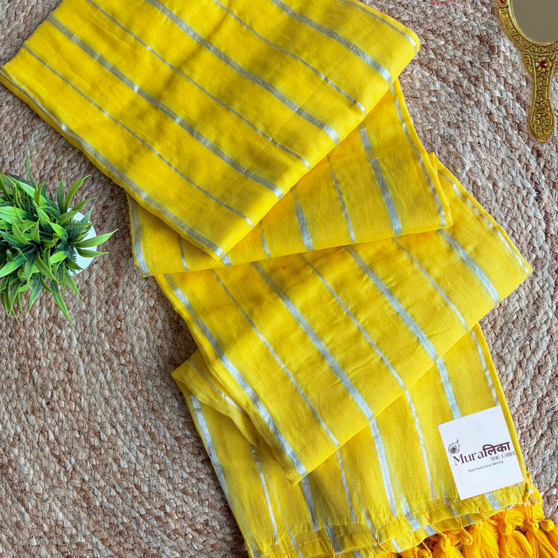 Haldi turmeric yellow mulmul cotton saree with fine silver stripes, folded flat