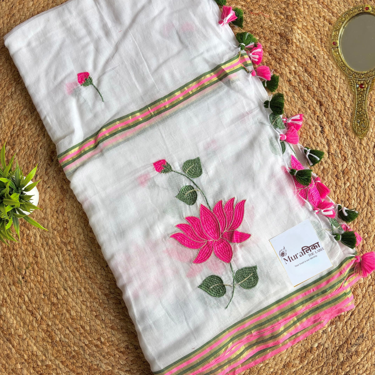Close view of pink lotus embroidery on the Kamal Talai white mulmul saree
