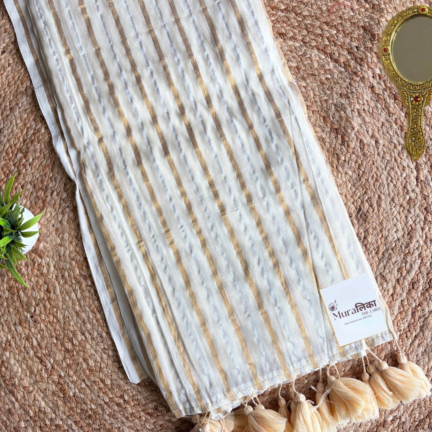 Ivory and gold striped mulmul cotton saree shown draped
