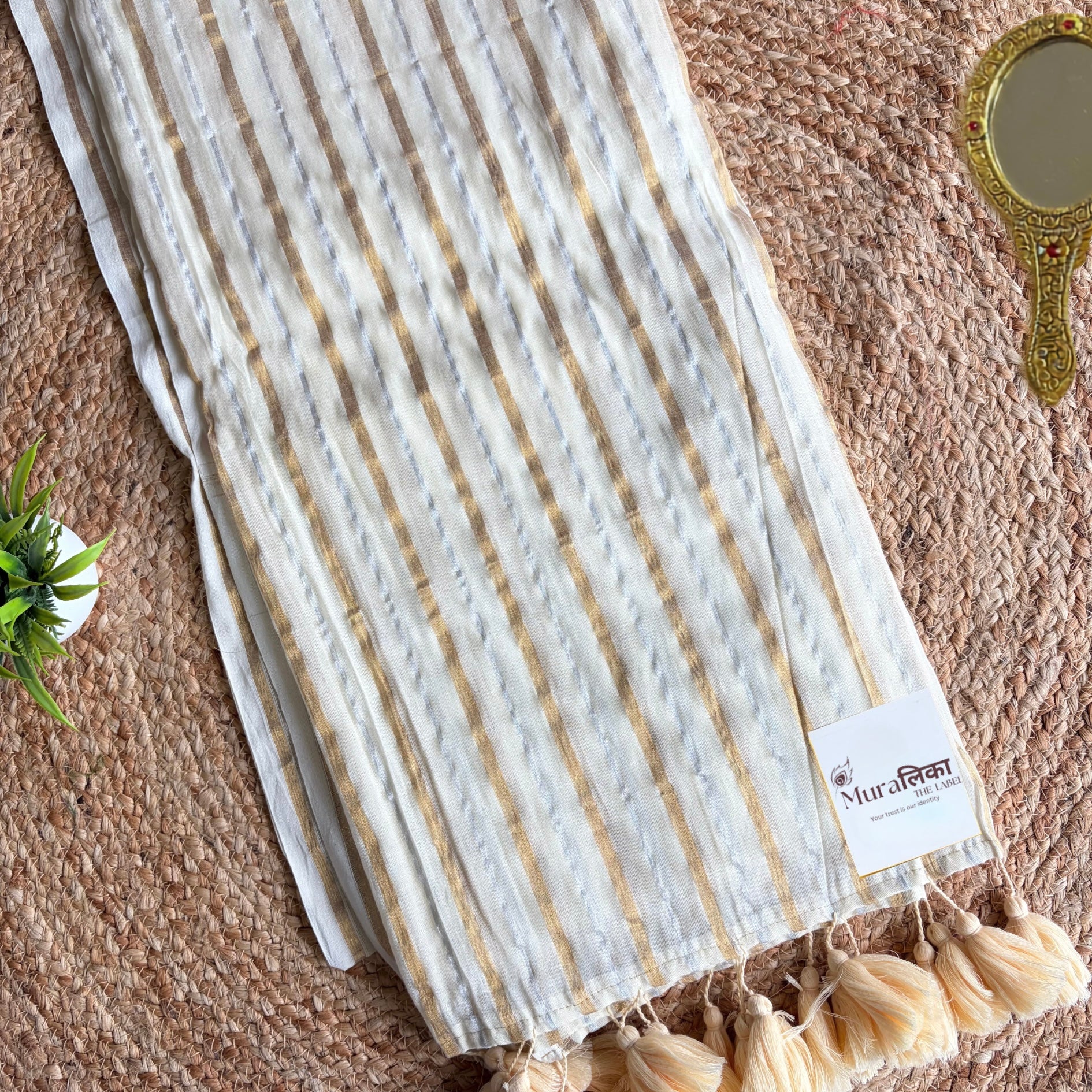 Ivory and gold striped mulmul cotton saree shown draped