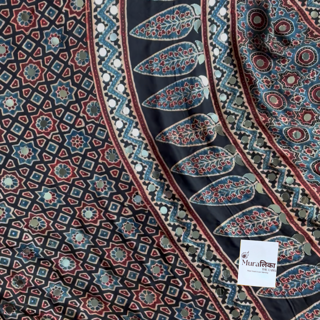 Chandani Ajrakh saree draped, showing the black-ground star lattice block print