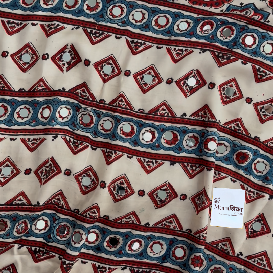 Close-up of the mirror work and medallion motifs on the Naina cream Ajrakh saree