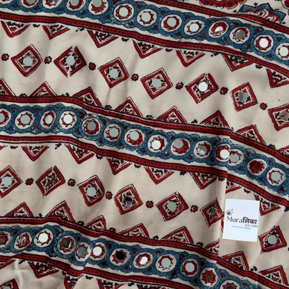 Close-up of the mirror work and medallion motifs on the Naina cream Ajrakh saree