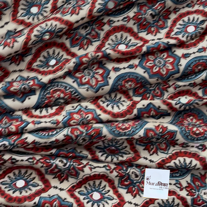 Naina cream Ajrakh saree draped, showing the cream-ground medallion block print