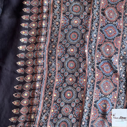 Elegant Ajrakh mirror work Modal silk saree by Muralika The Label with intricate traditional patterns and vibrant colors.