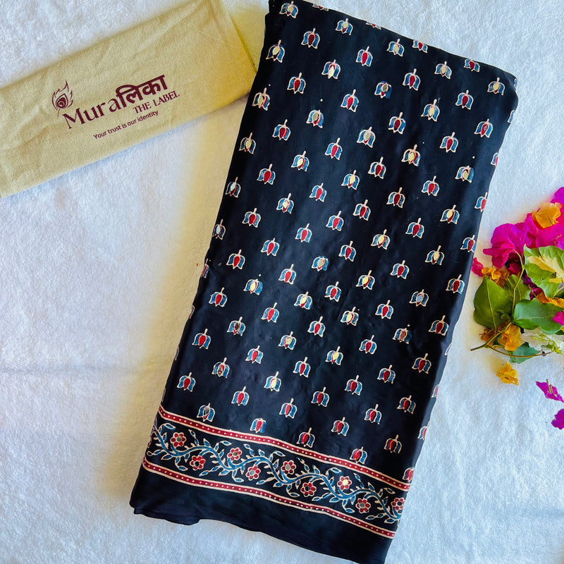 Elegant Ajrakh mirror work modal silk saree by Muralika The Label, featuring intricate mirror embroidery and vibrant traditional patterns.